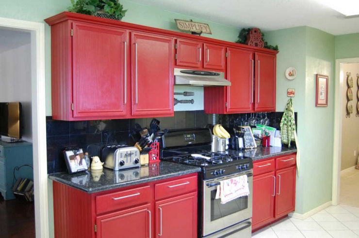simple-small-metal-gasstove-between-big-red-kitchen-cabinets-close-green-wall-paint